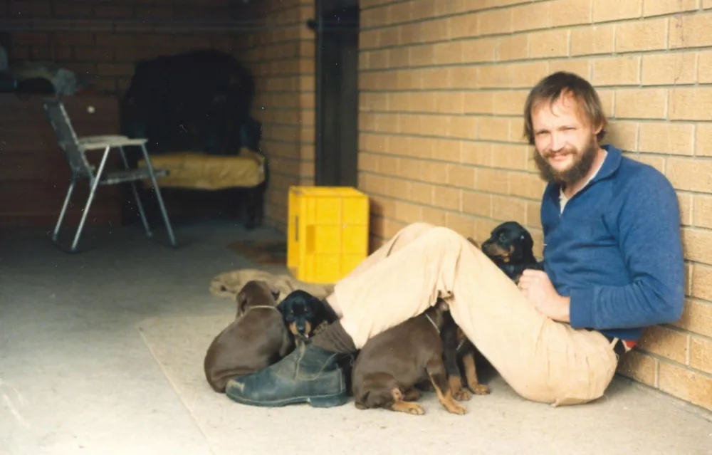 An early photo of the family with a litter of Dobermann puppies